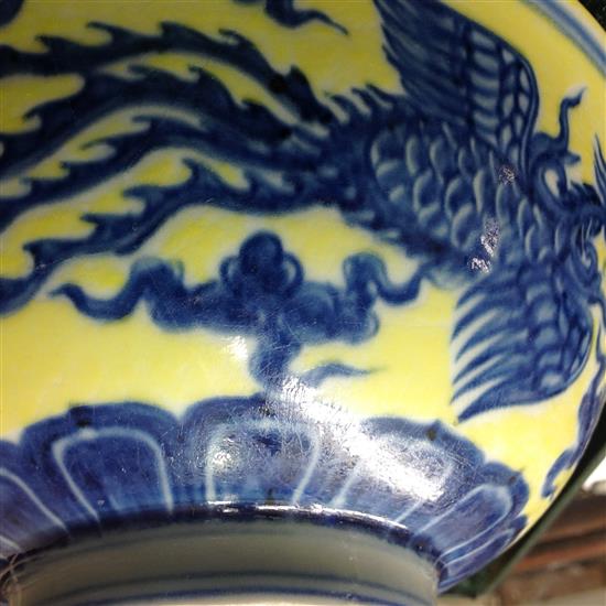 A Chinese yellow ground dragon and phoenix bowl, Xuande six character mark and possibly of the period, 19.5cm, museum restoration, sc